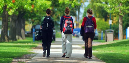 Three students walking outside.
