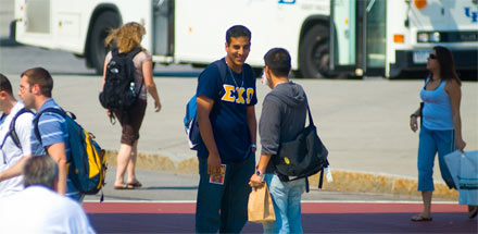 Students walking and talking outside on UB's North campus.